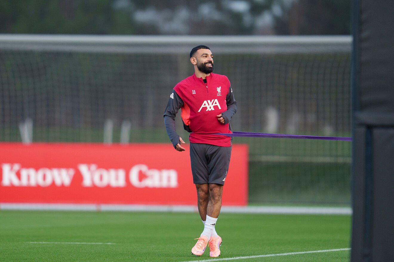 Liverpool's Mohamed Salah smiles as he takes part in a training...
