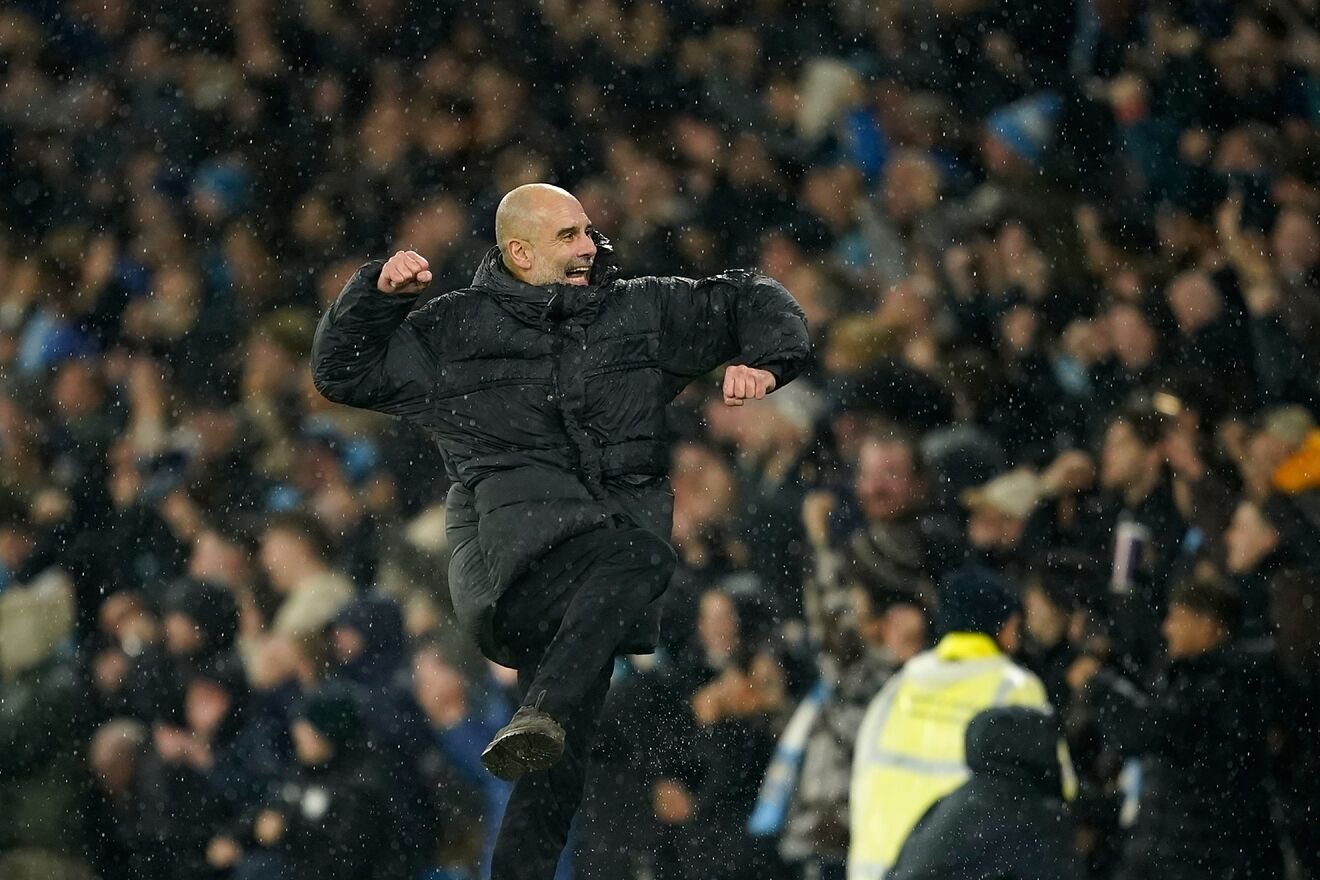 Pep Guardiola celebrates after Manchester City's Erling Haaland...